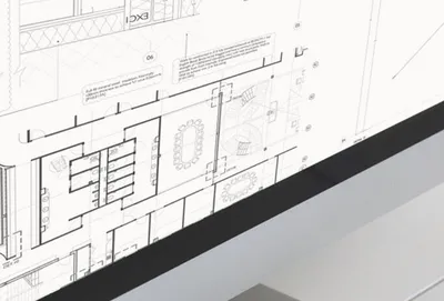 Architect reviewing drawings that specify natural stone finishes